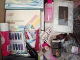a lot of nail polish and cosmetics items in a box