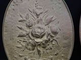 two silver coins with designs on them sitting next to each other