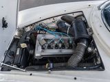 a small engine in the hood of a white car
