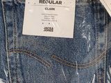 the back pocket of a pair of jeans with a tag on it
