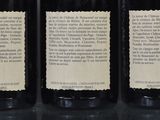 three bottles of wine are lined up on a table