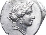 a close up of a coin with a woman ' s head on it