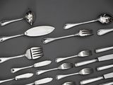 a lot of forks and spoons that are on the table