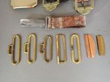 a lot of different types of belts and buckles on the table