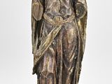 statue of a man in a robe holding a sword on a wooden base
