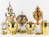 many different types of brass objects on a white surface