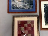 three framed pictures on the wall of a room