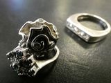 a silver ring with a rose on it next to a silver ring with a rose on it