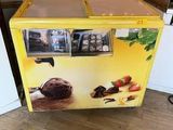 a yellow ice cream machine sitting in the middle of a kitchen