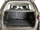 the back of a car with its trunk open and the back seats folded down
