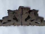 an antique cast iron shelf bracket with a horse and rider design