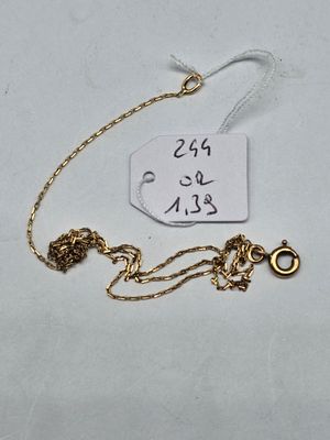 a close up of a gold chain with a tag on it