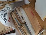 a box full of books and papers on a desk
