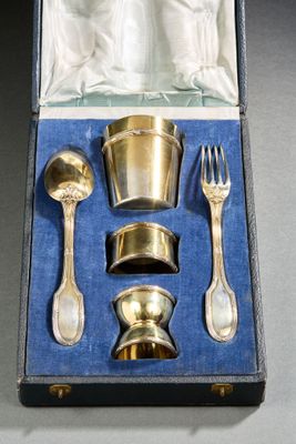 a silverware set in a case with a fork, spoon, and spoon rest