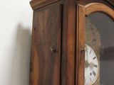 a wooden cabinet with a glass door and a clock on it
