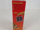 une boîte de tapis thermo sur une surface blanche