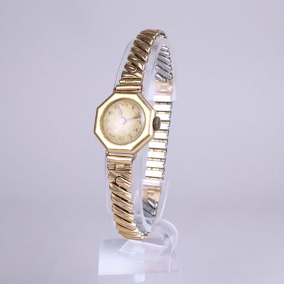 a close up of a wrist watch on a clear surface