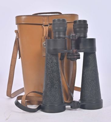 a brown bag and a pair of binoculars on a white surface