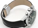a watch that is sitting on a black leather strap