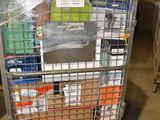 a metal cart with many items in it in a warehouse