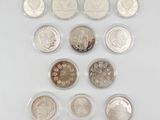 a close up of a bunch of coins on a white surface