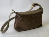 a small brown bag with a strap and a handle on a white background