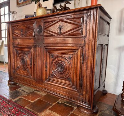 a large wooden cabinet in the middle of a living room