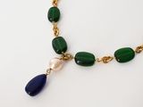 a green and blue beaded necklace with a pearl on it
