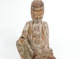 statue of a person sitting on a white surface with a white background