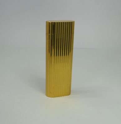 a gold lighter that is sitting on a white surface