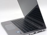 a laptop that is open on a white surface