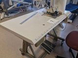 a table with a sewing machine on it in a hospital room