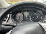 a steering wheel and dashboard of a car with a clock on it