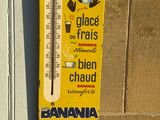 a thermometer hanging on the wall of a building