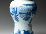 a blue and white vase sitting on a table