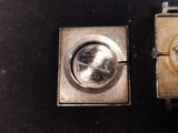 two watches sitting side by side on a black surface