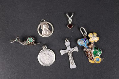 a close up of a group of religious charms on a black surface