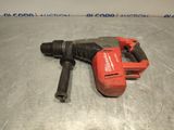 a close up of a drill on a metal surface with a red handle
