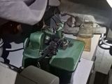 a man working on a green machine in a room
