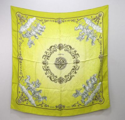 a yellow scarf with a picture of a bird and flowers on it