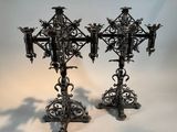 pair of antique metal candlesticks with ornate designs on them