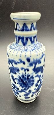 a blue and white vase sitting on a table
