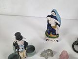 several figurines of people and animals on a white surface