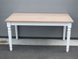 une photo d'une table blanche avec un plateau en bois posée sur un trottoir