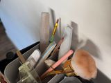 a lot of makeup brushes and other items in a suitcase