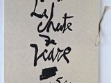 a white book with black writing on it sitting on top of a table