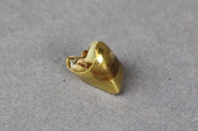 a small gold object that is on a table