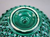 a green vase with a green lid sitting on a table