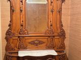 a wooden cabinet with a mirror on top of it