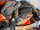a pile of clothes and a guitar in a box